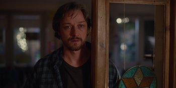 Movie still from “Together” (2021), directed by Justin Martin – A person standing next to a window; Close Up shot, Over the shoulder angle