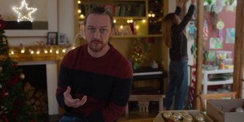 Movie still from “Together” (2021), directed by Justin Martin – A man sitting at a table in front of a woman; Medium shot, Over the shoulder angle