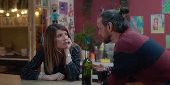 Movie still from “Together” (2021), directed by Justin Martin – A woman and a man sitting at a table with a glass of wine; Medium shot, Over the shoulder angle