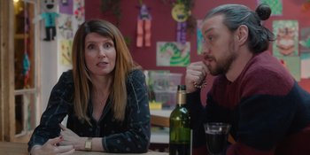 Movie still from “Together” (2021), directed by Justin Martin – A woman and a man are sitting at a table; Medium shot, Over the shoulder angle