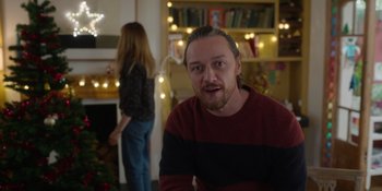 Movie still from “Together” (2021), directed by Justin Martin – A man in a red and black striped sweater and a woman in a red and black striped sweater; Medium shot, Over the shoulder angle