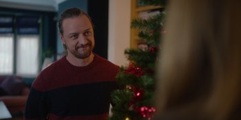 Movie still from “Together” (2021), directed by Justin Martin – A man standing in front of a christmas tree; Close Up shot, Over the shoulder angle