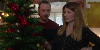 Movie still from “Together” (2021), directed by Justin Martin – A man and a woman looking at a christmas tree; Medium shot, Low angle