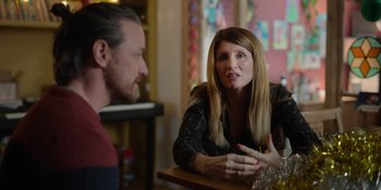 Movie still from “Together” (2021), directed by Justin Martin – A woman sitting at a table talking to a man; Medium shot, Over the shoulder angle