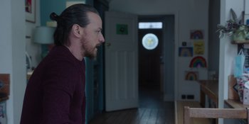 Movie still from “Together” (2021), directed by Justin Martin – A man standing in front of a door looking into a room; Medium shot, Over the shoulder angle