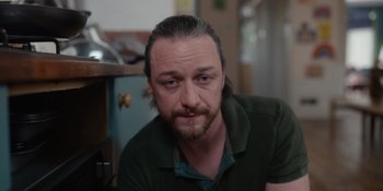 Movie still from “Together” (2021), directed by Justin Martin – A person with long hair and a beard; Close Up shot, Low angle