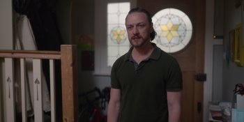 Movie still from “Together” (2021), directed by Justin Martin – A man standing in front of a stained glass window; Medium shot, Over the shoulder angle