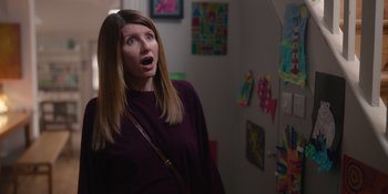 Movie still from “Together” (2021), directed by Justin Martin – A woman with long blonde hair is looking surprised; Medium shot, Over the shoulder angle