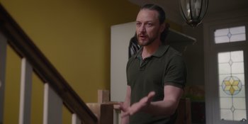 Movie still from “Together” (2021), directed by Justin Martin – A man standing in front of a staircase; Medium shot, Over the shoulder angle