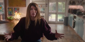 Movie still from “Together” (2021), directed by Justin Martin – A woman in a purple shirt is gesturing with her hands; Medium shot, Over the shoulder angle