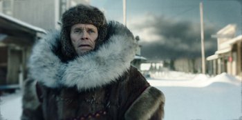 Movie still from “Togo” (2019), directed by Ericson Core – A man wearing a fur coat and a fur hat; Close Up shot, Low angle