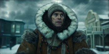 Movie still from “Togo” (2019), directed by Ericson Core – An old man wearing a fur coat and a hat; Close Up shot, Low angle