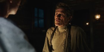 Movie still from “Togo” (2019), directed by Ericson Core – A man in a tan shirt and suspenders looking up; Close Up shot, Low angle