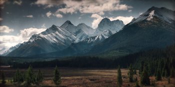 Movie still from “Togo” (2019), directed by Ericson Core – A view of a mountain range with snow on the top; Extreme Wide shot, High angle