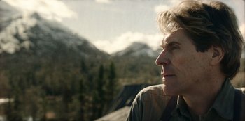 Movie still from “Togo” (2019), directed by Ericson Core – An older man looking out over a mountain valley; Close Up shot, Low angle