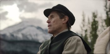 Movie still from “Togo” (2019), directed by Ericson Core – A person wearing a hat; Close Up shot, Low angle