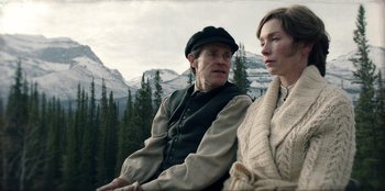 Movie still from “Togo” (2019), directed by Ericson Core – A man and a woman sitting next to each other on top of a hill; Medium shot, Over the shoulder angle