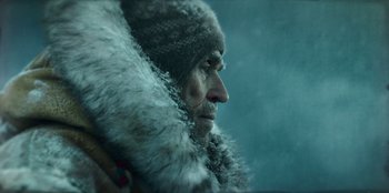 Movie still from “Togo” (2019), directed by Ericson Core – A person wearing a fur coat; Close Up shot, Low angle