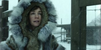 Movie still from “Togo” (2019), directed by Ericson Core – A woman in a fur coat looking out of a window; Close Up shot, Over the shoulder angle