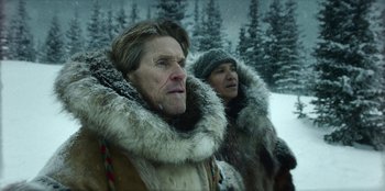 Movie still from “Togo” (2019), directed by Ericson Core – A man and a woman in fur coats standing next to each other in the snow; Close Up shot, Low angle