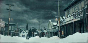 Movie still from “Togo” (2019), directed by Ericson Core – A snowy street with a church in the background; Extreme Wide shot, High angle