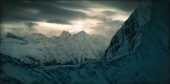Movie still from “Togo” (2019), directed by Ericson Core – A view of a mountain range with snow on it; Extreme Wide shot, Low angle