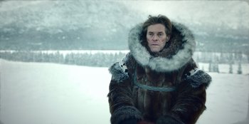 Movie still from “Togo” (2019), directed by Ericson Core – A man wearing a fur coat and a fur hat; Close Up shot, Low angle