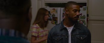 Movie still from “Without Remorse” (2021), directed by Stefano Sollima – A man and a woman standing in a kitchen next to each other; Close Up shot, Over the shoulder angle