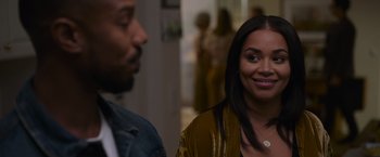 Movie still from “Without Remorse” (2021), directed by Stefano Sollima – A woman and a man are smiling for the camera; Close Up shot, Over the shoulder angle