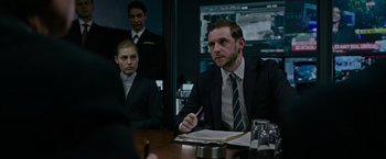 Movie still from “Without Remorse” (2021), directed by Stefano Sollima – A group of people sitting around a table; Medium shot, Over the shoulder angle