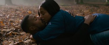 Movie still from “Without Remorse” (2021), directed by Stefano Sollima – A man and a woman are kissing in the leaves; Close Up shot, High angle