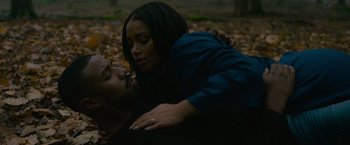 Movie still from “Without Remorse” (2021), directed by Stefano Sollima – A man and a woman in a field of leaves; Medium shot, High angle