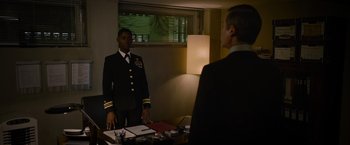 Movie still from “Without Remorse” (2021), directed by Stefano Sollima – A man in a uniform standing in front of a man in a suit; Medium shot, Over the shoulder angle