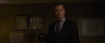 Movie still from “Without Remorse” (2021), directed by Stefano Sollima – A man in a suit and tie standing in front of a mirror; Close Up shot, Over the shoulder angle