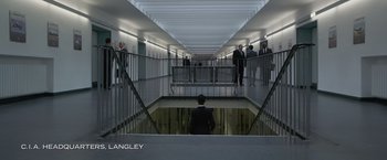 Movie still from “Without Remorse” (2021), directed by Stefano Sollima – A group of people standing around a building; Extreme Wide shot, High angle