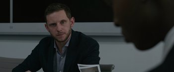 Movie still from “Without Remorse” (2021), directed by Stefano Sollima – A man sitting at a table looking at the camera; Close Up shot, Over the shoulder angle
