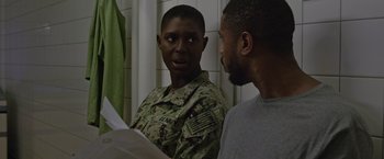 Movie still from “Without Remorse” (2021), directed by Stefano Sollima – Two men are talking to each other in a bathroom; Close Up shot, Over the shoulder angle