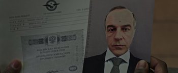 Movie still from “Without Remorse” (2021), directed by Stefano Sollima – A man in a suit and tie next to a passport; Close Up shot, Low angle