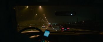 Movie still from “Without Remorse” (2021), directed by Stefano Sollima – A view from a car of a highway at night; Wide shot, Low angle