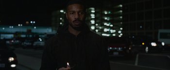 Movie still from “Without Remorse” (2021), directed by Stefano Sollima – A man holding a lit candle in a dark place; Close Up shot, Low angle