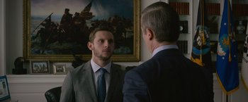 Movie still from “Without Remorse” (2021), directed by Stefano Sollima – A man in a suit and tie looking at himself in the mirror; Medium shot, Over the shoulder angle