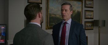 Movie still from “Without Remorse” (2021), directed by Stefano Sollima – A man in a suit and tie talking to another man in a suit and tie; Medium shot, Over the shoulder angle