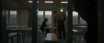 Movie still from “Without Remorse” (2021), directed by Stefano Sollima – Two men standing at a table in a room; Wide shot, Over the shoulder angle