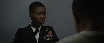 Movie still from “Without Remorse” (2021), directed by Stefano Sollima – A woman in a military uniform talking to a man; Close Up shot, Over the shoulder angle
