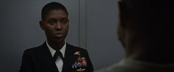 Movie still from “Without Remorse” (2021), directed by Stefano Sollima – A woman in a military uniform looking at a man in a suit; Close Up shot, Over the shoulder angle