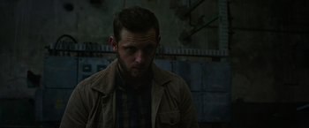 Movie still from “Without Remorse” (2021), directed by Stefano Sollima – A person wearing a shirt and jacket; Close Up shot, Low angle