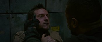 Movie still from “Without Remorse” (2021), directed by Stefano Sollima – A man is getting his hair combed by another man; Close Up shot, Over the shoulder angle