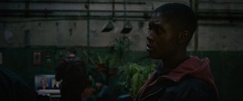 Movie still from “Without Remorse” (2021), directed by Stefano Sollima – A young man is looking into the distance; Close Up shot, Over the shoulder angle