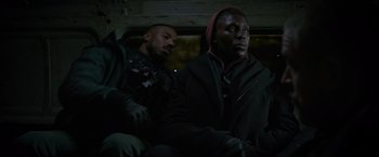 Movie still from “Without Remorse” (2021), directed by Stefano Sollima – Two men sitting next to each other in the dark; Medium shot, Over the shoulder angle