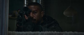 Movie still from “Without Remorse” (2021), directed by Stefano Sollima – A person holding a gun; Close Up shot, Over the shoulder angle